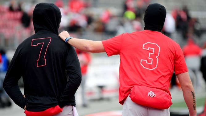 Quinn Ewers and CJ Stroud share a moment before Ohio State played Michigan State in 2021