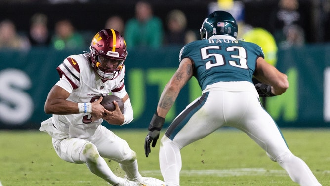 Washington Commanders QB Jayden Daniels slides in front of Philadelphia Eagles LB Zack Baun at Lincoln Financial Field in NFL Week 11. (Photo credit: Bill Streicher-Imagn Images)
