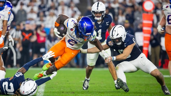 Boise State Broncos RB Ashton Jeanty is tackled by the Penn State Nittany Lions during the Fiesta Bowl in the Quarterfinals of the 2024-25 College Football Playoff at State Farm Stadium in Glendale, Arizona. (Image credit: Mark J. Rebilas-Imagn Images). 