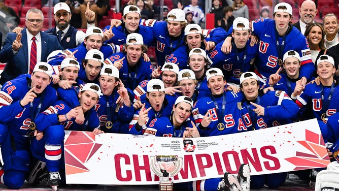 Team USA pose with the IIHF Cup after winning gold against Team Finland during the 2025 IIHF World Junior Championship at Canadian Tire Centre in Ottawa, Ontario.
