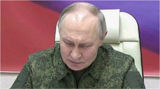 Russian leader Vladimir Putin wore combat fatigues during a visit to Kursk. Check out photos of the visit. (Photo by Kremlin Press Office / Handout/Anadolu via Getty Images)