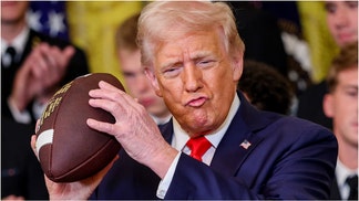 President Donald Trump was caught on video sharing a touching moment with Navy band members at the White House. Watch the video. (Photo by Win McNamee/Getty Images)