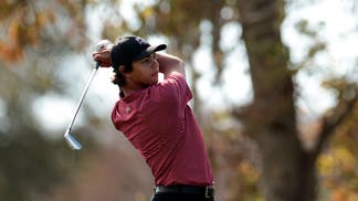 Charlie Woods swinging an iron