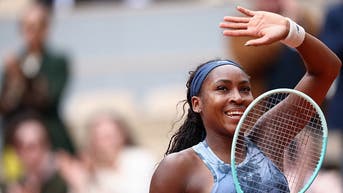 Coco Gauff waves to crowd at Roland-Garros