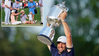 Scottie Scheffler hoisting the Wanamaker Trophy