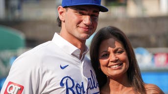 Jac Caglianone smiles with his mother while wearing his Royals uniform