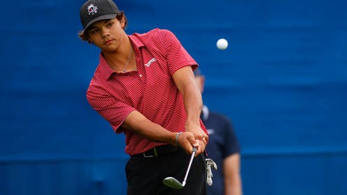 Charlie Woods hitting a chip shot