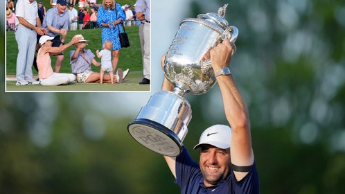 Scottie Scheffler hoisting the Wanamaker Trophy