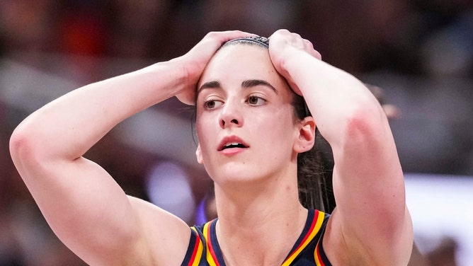 Caitlin Clark with her hands on her head