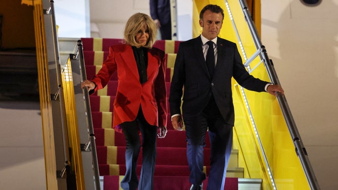 french president Emmanuel Macron and first lady Brigitte Macron after she shoved him in the face on a plane in vietnam