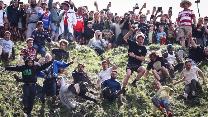 viral video shows man flying through the air at annual cheese rolling festival