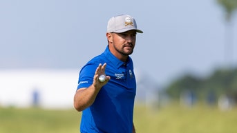 Bryson DeChambeau waving to fans