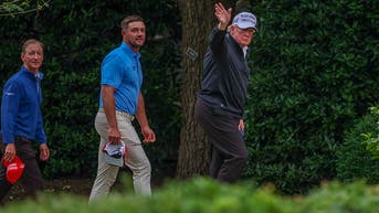 Bryson DeChambeau and Donald Trump waving to cameras