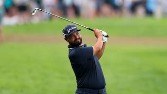 JJ Spaun hitting an iron shot at the U.S. Open at Oakmont