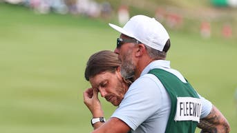Tommy Fleetwood at the Travelers Championship next to caddie