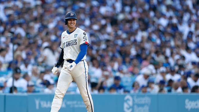 Shohei Ohtani smiles as he walks down the third base line