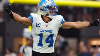 Amon-Ra St. Brown of the Lions celebrates on the field.