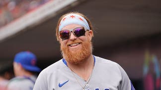 Justin Turner smiling in the Cubs' dugout
