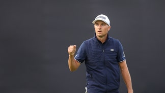 Jordan Spieth fist pumps after holing putt.