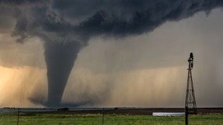 storm-chasing couple engaged in front of a tornado