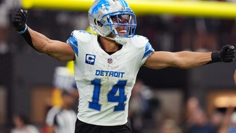 Amon-Ra St. Brown of the Lions celebrates on the field.