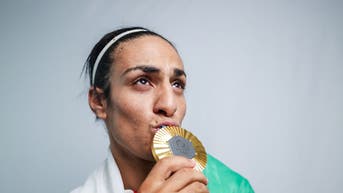 Imane Khelif kissing an Olympic medal