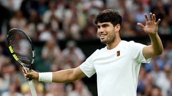 Carlos Alcaraz smiles at Wimbledon.
