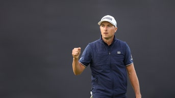 Jordan Spieth fist pumps after holing putt.
