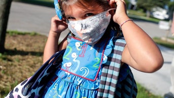 a child wearing a COVID mask