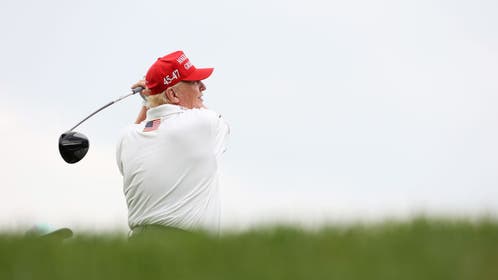 Donald Trump swinging a driver.