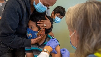 A child receiving a COVID vaccine