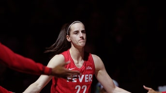 Caitlin Clark high-fiving Indiana Fever teammates