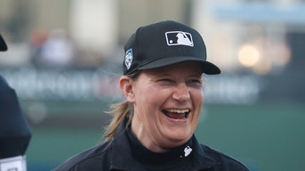 MLB umpire Jen Pawol smiling on the diamond