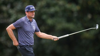 Keegan Bradley holding his putter