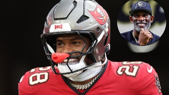 Shilo Sanders and Deion Sanders smiling