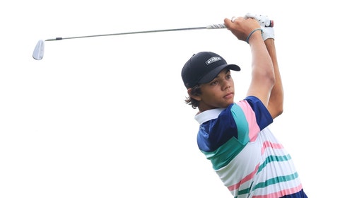 Charlie Woods swinging an iron