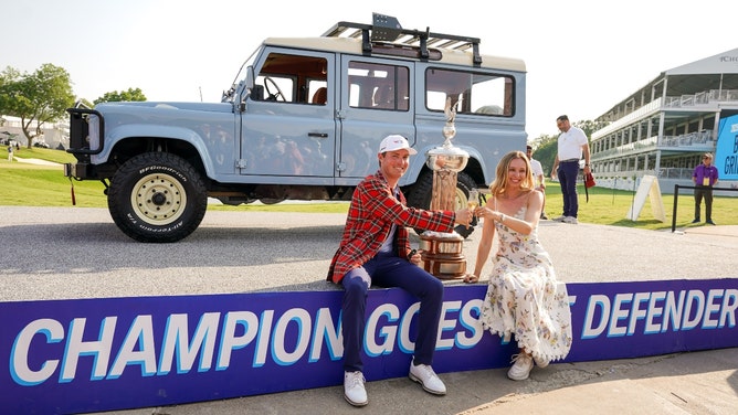 Ben Griffin posing with his fiancee and the championship trophy after winning the 2025 Charles Schwab Challenge. (Photo Credit: Raymond Carlin III-Imagn Images)