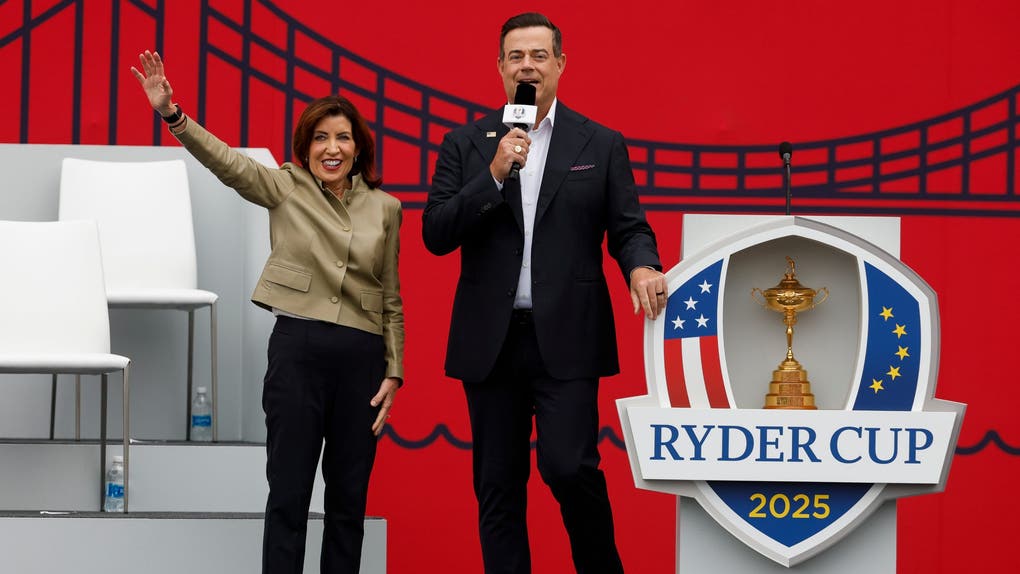 Kathy Hochul, governor of New York, and Carson Daly speak to the crowd during the opening ceremony for the 2025 Ryder Cup at Black Course at Bethpage State Park Golf Course on September 24, 2025 in Farmingdale, New York. 