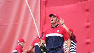 Bryson DeChambeau popping a bottle of champagne