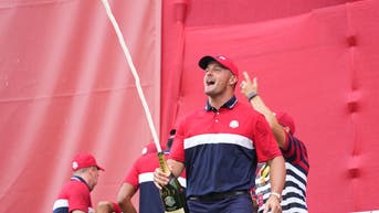 Bryson DeChambeau popping a bottle of champagne