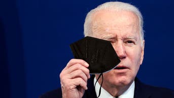 Joe Biden holding a COVID-19 mask