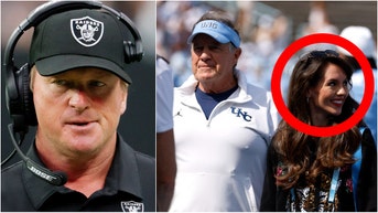Jon Gruden sarcastically took a shot at the behavior of UNC coach Bill Belichick and his girlfriend Jordon Hudson. Watch a video of his comments. What did he say? (Photo by Ethan Miller/Getty Images and Photo by Lance King/Getty Images)