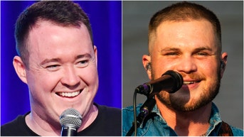 Comedian Shane Gillis linked up with Zach Bryan at his Notre Dame show, and the video footage is incredible. Watch the video. (Photo by Lorne Thomson/Redferns and Photo by Jeff Kravitz/FilmMagic for Clusterfest via Getty Images)