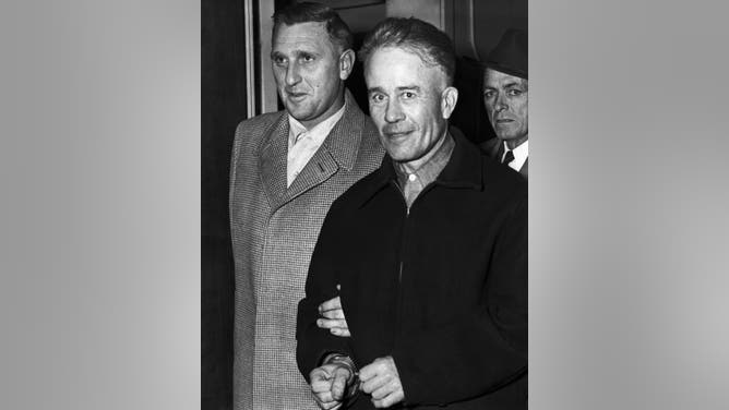 Serial killer Ed Gein is escorted from the Wisconsin State Crime Laboratory to the county jail after confessing to two murders. (Credit: Getty Images)