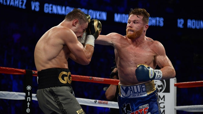 Saul 'Canelo' Alvarez lands a punch on Gennady Golovkin during a world middleweight boxing championship fight at T-Mobile Arena in Las Vegas. (Photo Credit: Joe Camporeale-USA TODAY Sports)