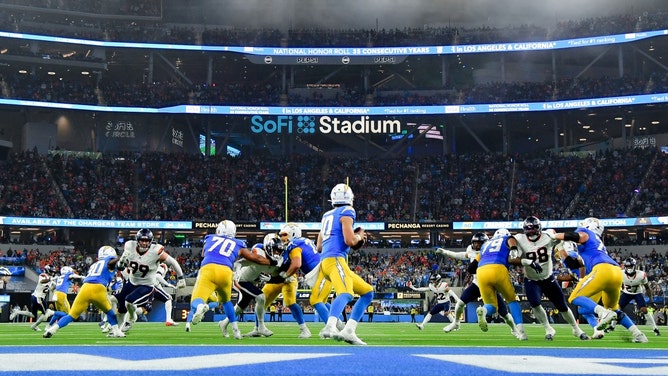 Los Angeles Chargers QB Justin Herbert drops back to pass against the Denver Broncos at SoFi Stadium. (Photo Credit: Gary A. Vasquez-Imagn Images)