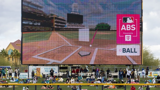 Stadium Jumbotron displaying the ABS challenge animated pitch graphic during a spring training game, showing the 3D pitch location overlay on the strike zone transmitted over T-Mobile private 5G.