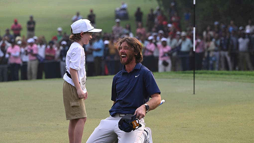 Tommy Fleetwood and his son celebrating victory on a green