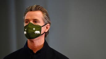 Gavin Newsom wearing a COVID mask