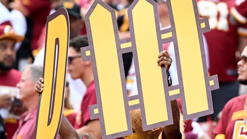 sad commanders fan fight during loss to bears